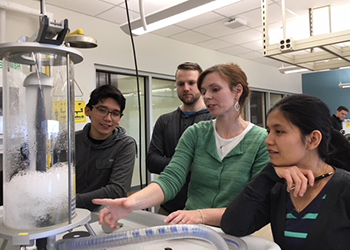 Students are working in the new fluid dynamics and heat transfer lab at the SciTech Campus. Pictured here: Esteban Perez (left), Luke Jameson, lab manager Elisabeth Lattanzi, and Wint Zaw.